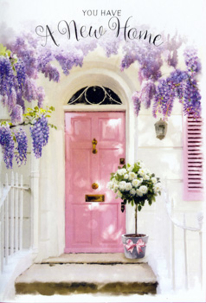 The photograph evokes the feeling of arriving at a freshly painted home in Gidea Park, where thoughtful flowers soften every line of the doorway. Dominating the centre is a pretty pink front door, finished in a gentle blush tone that glows with a welcoming warmth against the minimalist whitewashed exterior. One side of the entrance is framed by a pastel shutter, slightly ajar or simply resting in the sun, suggesting a home that is airy and light-filled within. Overhead, cascading strands of wisteria fall in loose, tumbling garlands of lavender and soft purple, their delicate blossoms hanging in textured clusters that cast dappled shadows over the door and step. At the base of this floral frame, on the threshold itself, a grey metal bucket has been placed with intention. It brims with generous white and cream roses, the blooms open and plush, revealing layered petals that look almost velvety to the touch. Interwoven among them are soft green sprigs of foliage, adding contrast and a sense of natural movement. Around the bucket's base, a pale pink ribbon is tied in a simple yet elegant bow, its satin sheen catching the light and quietly mirroring the blush door behind it. The overall mood is calm and quietly celebratory, as if a local florist in Gidea Park has just made a same-day delivery to mark someone's move into their new address. You can imagine the hush of a side street near Gidea Park station, the gentle creak of the gate, and the faint fragrance of roses and wisteria hanging in the air. It is a scene steeped in optimism and tenderness, perfect for commemorating new beginnings and offering a warm, floral welcome home.